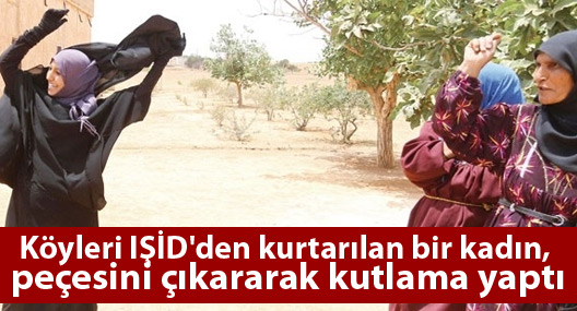 Köyleri IŞİD'den kurtarılan bir kadın, peçesini çıkararak kutlama yaptı