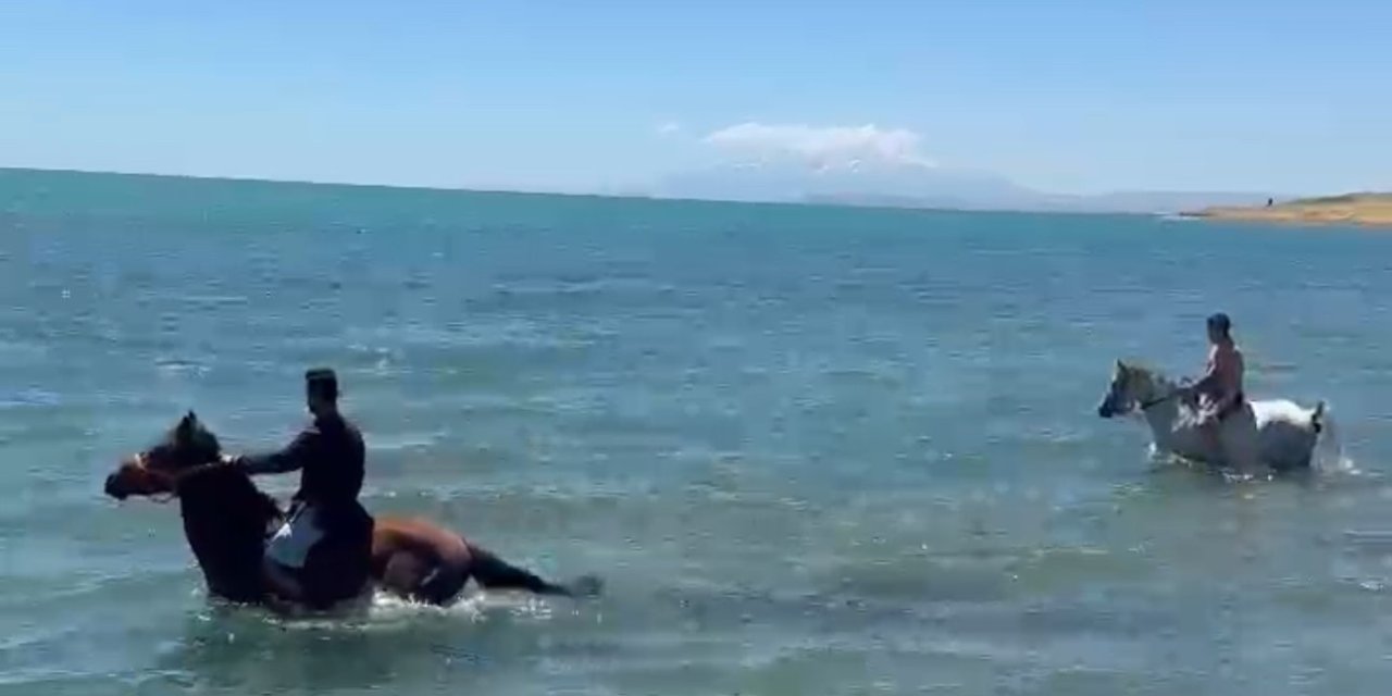 Sıcaktan bunalan gençler atlarıyla Van Gölü’nde serinledi